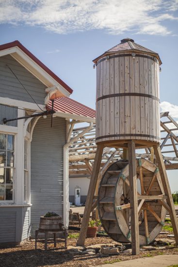 water tower with wheel next to a building
